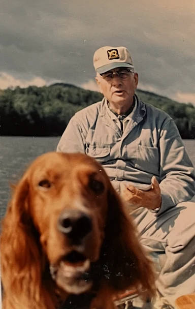 Fred Logan Bull (1902–1986) — the first generation, who built the Lodge — on Santa Claus Lake in his canoe; Red, his son Robert’s dog, mindi…