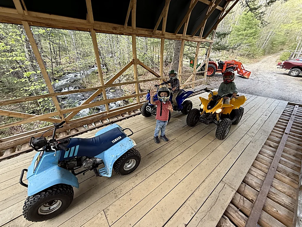 The fourth generation — Robbie, Nathan, and Teddy Bull — riding their quads over to see Chris and Ashirah at the Maine Local Living School.