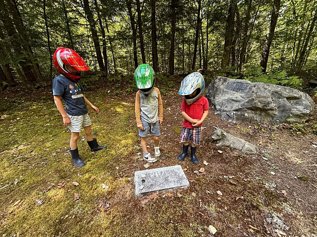 Robbie, Nathan, and Teddy — helmets still on from the ride — visiting their grandfather Robert Logan Bull and their uncle Steve.